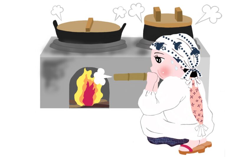 かまどでご飯を炊くお母さん